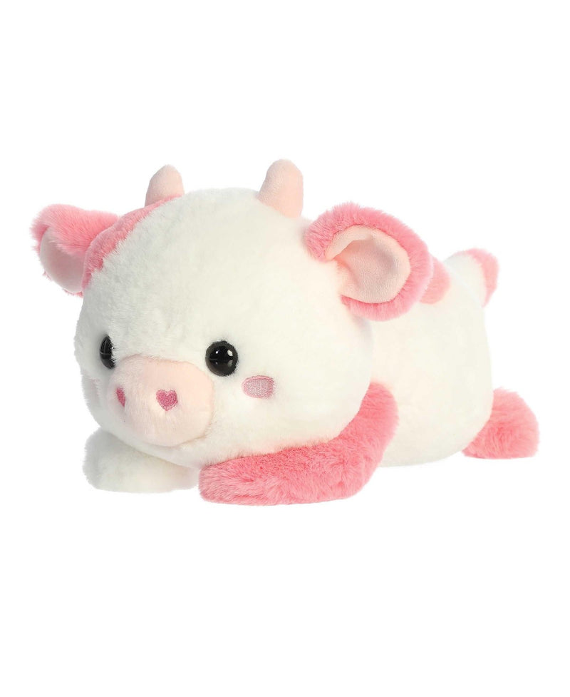 Katelyn Cow plush by Aurora in white and pink, lying belly-down with sparkling eyes and a heart-shaped nose for Valentine&