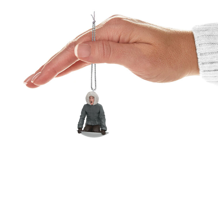 Hallmark Keepsake Mini National Lampoon’s Christmas Vacation Sledding Clark ornament—Clark in parka on saucer sled, startled expression, snowy hill
