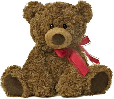 Brown teddy bear with a red ribbon tied around its neck. It has black eyes and a stitched smile.