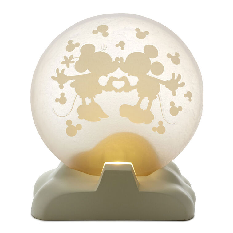 Light-up Mickey and Minnie figurine with heart hands silhouette on a frosted moon and “Over the moon” quote on the base.