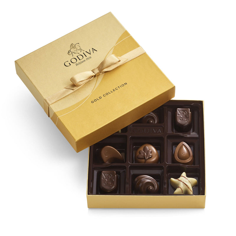 A 9-piece Godiva chocolate gift box in gold with ribbon, featuring assorted milk, dark, and white chocolates in rich, creamy, and crunchy flavors.

