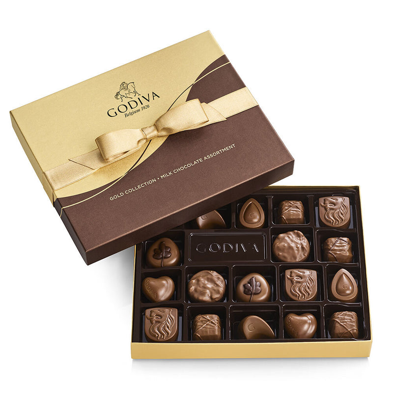 An 18-piece Godiva milk chocolate gift box tied with a gold ribbon, filled with silky smooth assorted chocolates in a variety of textures and flavors.


