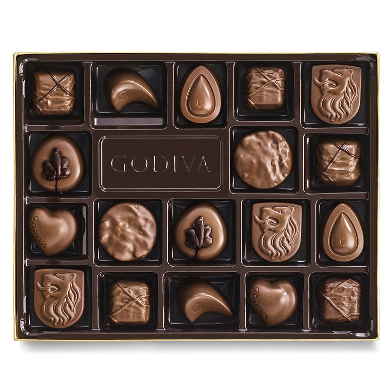 An 18-piece Godiva milk chocolate gift box tied with a gold ribbon, filled with silky smooth assorted chocolates in a variety of textures and flavors.

