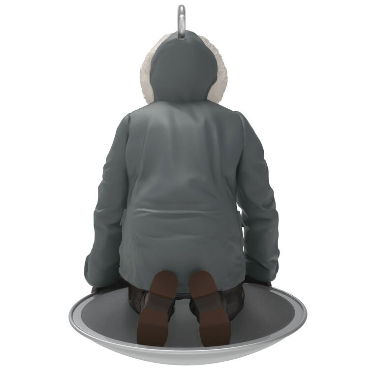 Hallmark Keepsake Mini National Lampoon’s Christmas Vacation Sledding Clark ornament—Clark in parka on saucer sled, startled expression, snowy hill