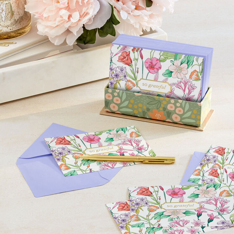 Floral thank-you cards with colorful wildflowers and greenery around a gold-framed “so grateful” message.
