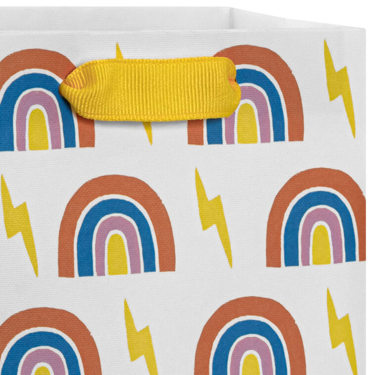 Small Hallmark gift bag with colorful rainbows and yellow lightning bolts on a white background with yellow ribbon handles.