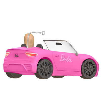 Barbie ornament driving a pink convertible sports car, wearing pink tee and barrettes, Hallmark Keepsake holiday decoration.