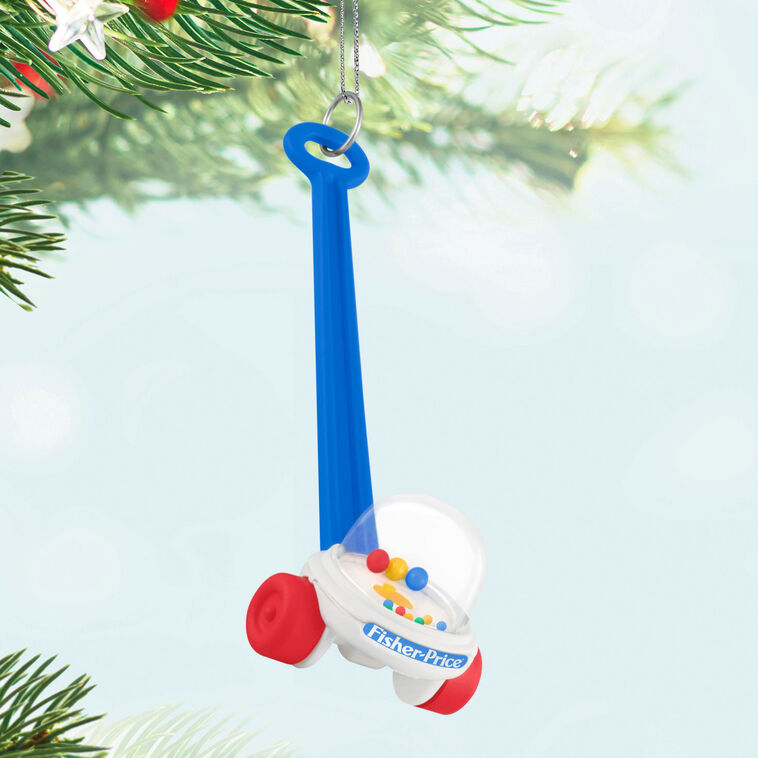 Mini Corn Popper ornament with red wheels, blue handle, and clear dome filled with colorful popping balls.

