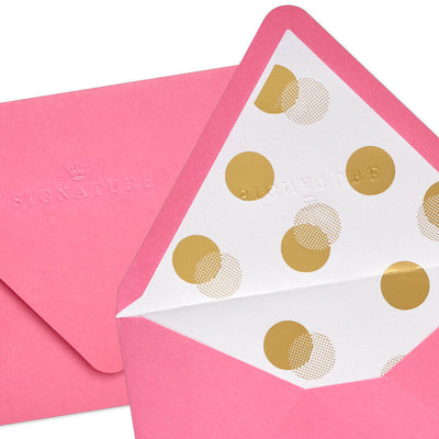 Bright pink envelopes with gold and white halftone dot design inside the flap and pointed edges.
