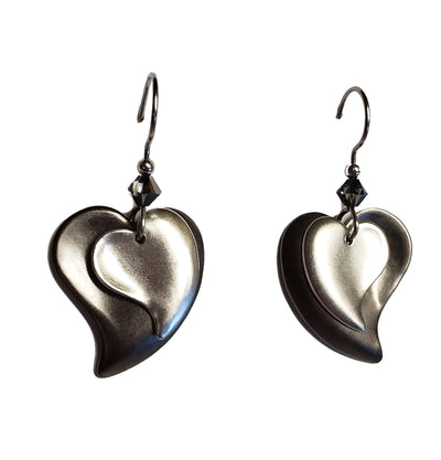 Layered silver-tone heart drop earrings with crystal accent and surgical steel ear wires.
