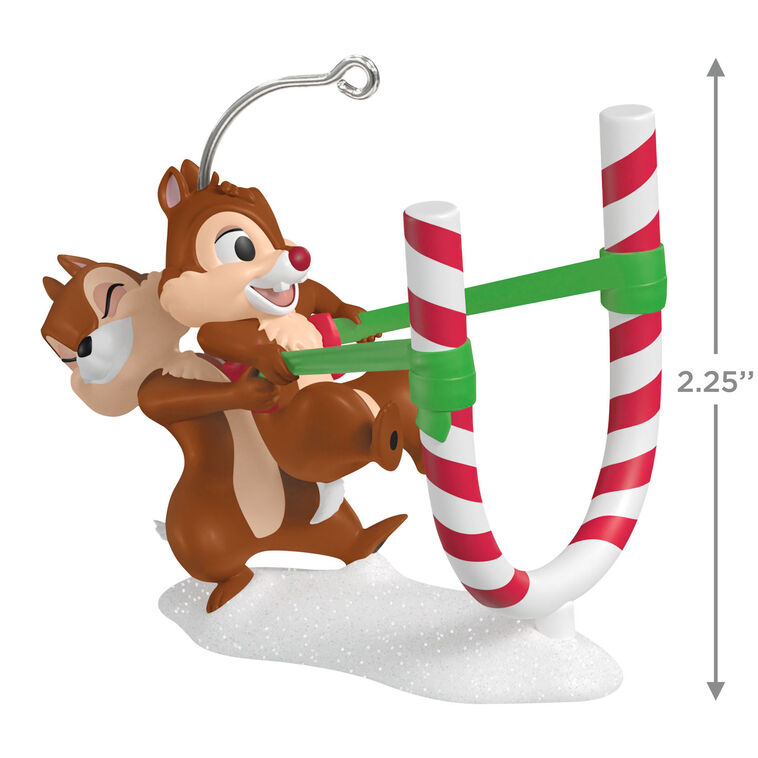 Chip launches Dale from a candy cane catapult in this playful Hallmark Keepsake Disney Christmas ornament with snowy base.