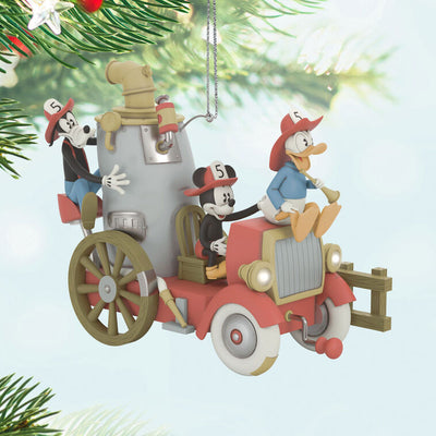 Mickey, Donald, and Goofy on a vintage fire engine ornament with light, sound, and motion from Mickey’s Fire Brigade.

