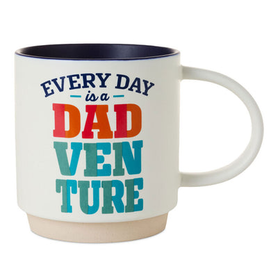 White ceramic mug with colorful "Every day is a Dadventure" lettering, oversized handle, and recessed base for stacking