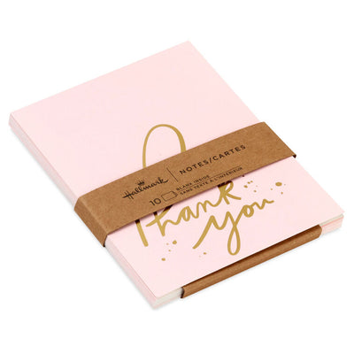 Pink thank-you cards with gold foil script and looped lettering, featuring delicate gold flecks.
