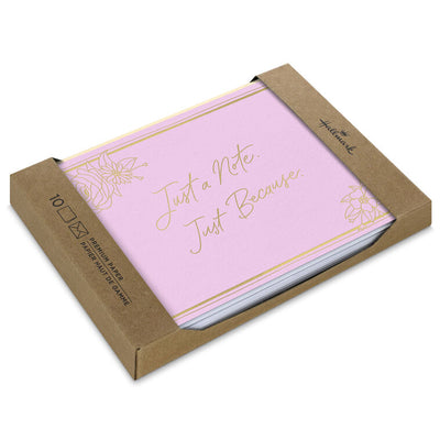 Rose pink blank note cards with gold script lettering and floral corner sketches in kraft box.
