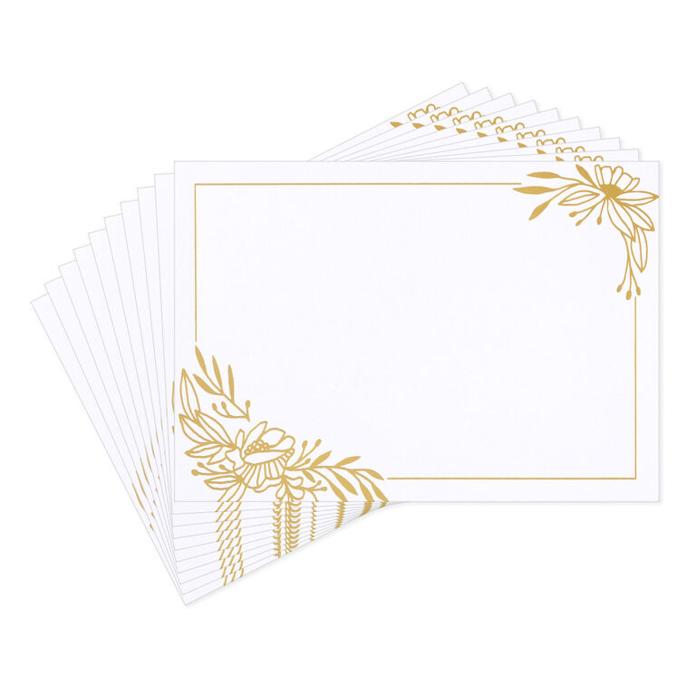 White flat note cards with gold foil corner floral swags and kraft band packaging.
