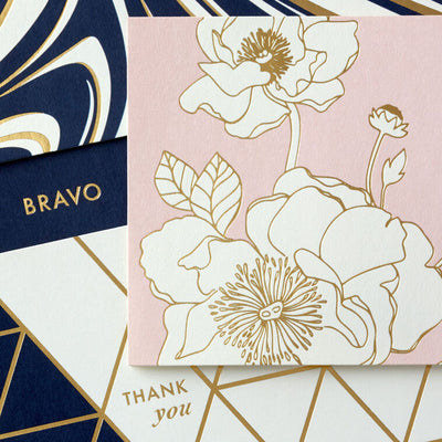 Assorted note card box with blush, navy, and gold foil floral, geometric, and marble designs; includes 24 cards and envelopes