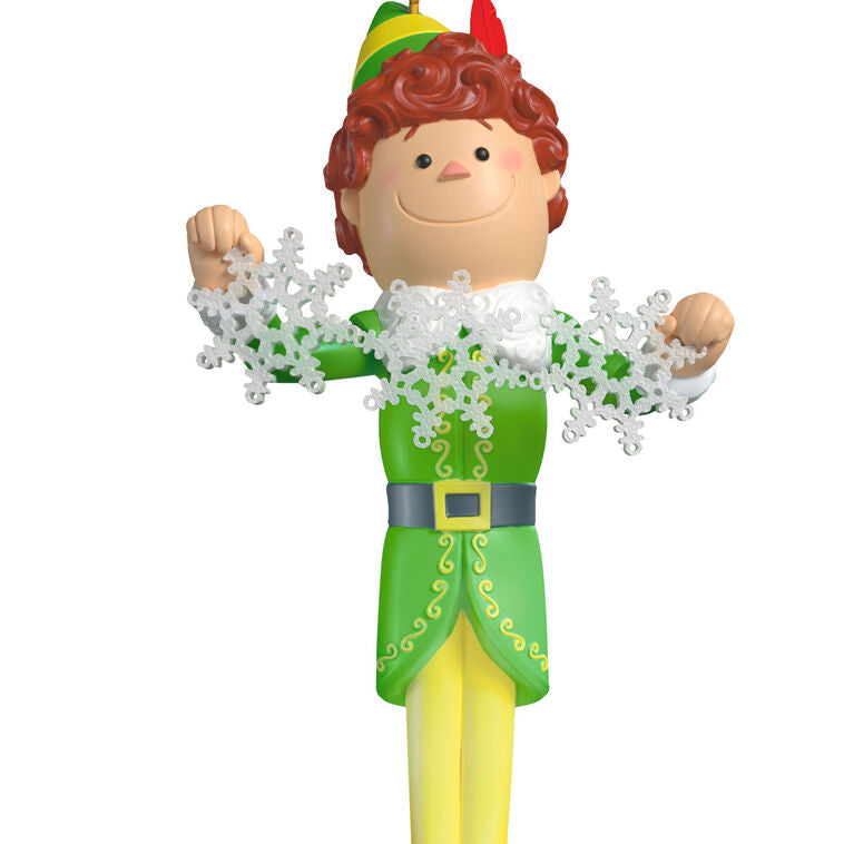 Buddy the Elf ornament with light and sound, standing on red base in green costume with snowflakes, inspired by the movie “Elf”