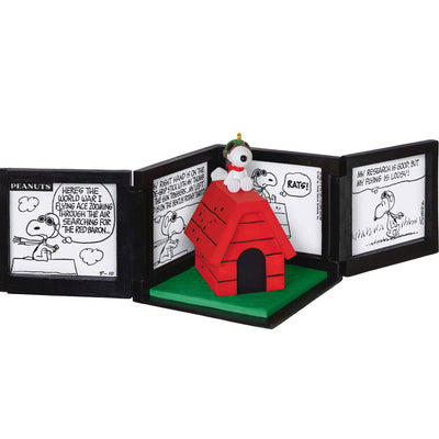 Snoopy as the Flying Ace on red doghouse airplane, comic panel backdrop, Peanuts 75th anniversary Hallmark Christmas musical ornament
