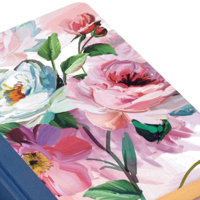 Hardcover journal with purple and pink floral fabric cover, gold-edged pages, and ribbon bookmark.
