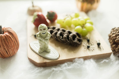 Nora Fleming mummy mini wrapped in white bandages with playful eyes; spooky Halloween table accent; hand wash only.

