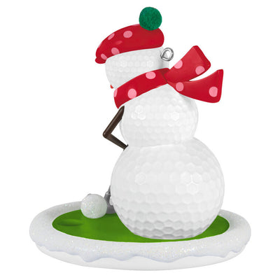 Golf ball snowman ornament in red polka dot hat and scarf, hitting a snowball with a silver putter

