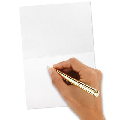 Blush pink thank-you cards with gold foil “Merci” script lettering and matching foil-lined envelopes in a white display box.
