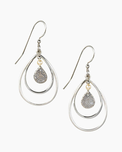 Nested teardrop dangle earrings with ivory glass pearl and textured silver-tone finish.
