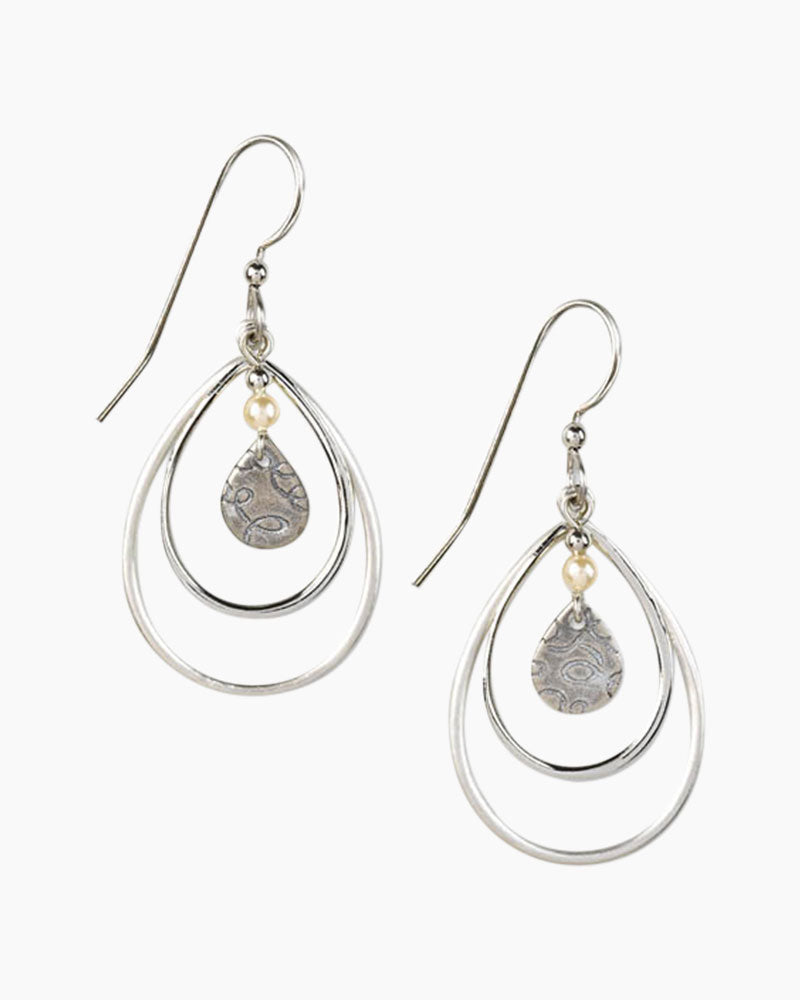 Nested teardrop dangle earrings with ivory glass pearl and textured silver-tone finish.
