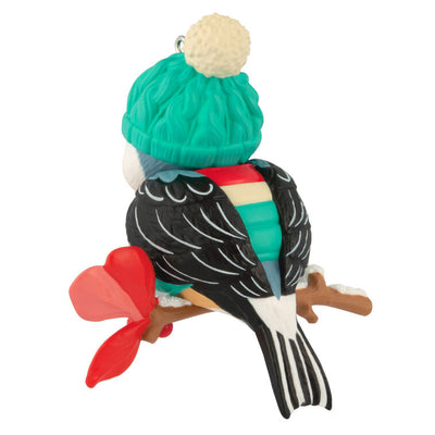 Hallmark Keepsake Cozy Critters ornament—black-capped chickadee in teal stocking hat and striped vest perched on holly branch with glittery snow