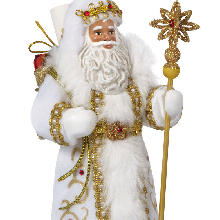 Black Father Christmas ornament in white coat with gold staff, faux-fur trim, and red gem accents.

