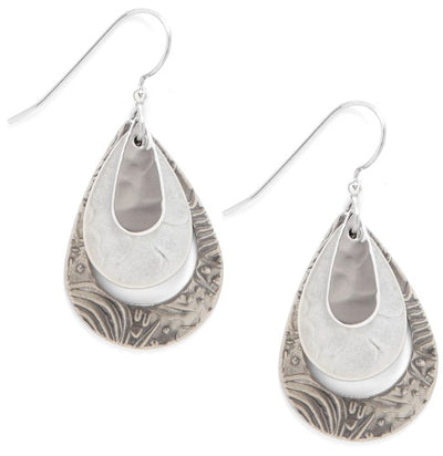 Nested silver teardrop drop earrings with smooth and textured finishes.

