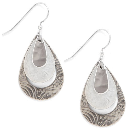 Nested silver teardrop drop earrings with smooth and textured finishes.
