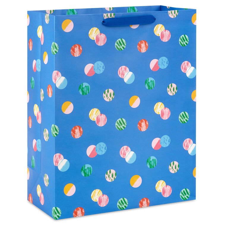 Hallmark extra-large gift bag with playful polka dots on a blue background, ideal for birthdays, holidays, or celebrations.