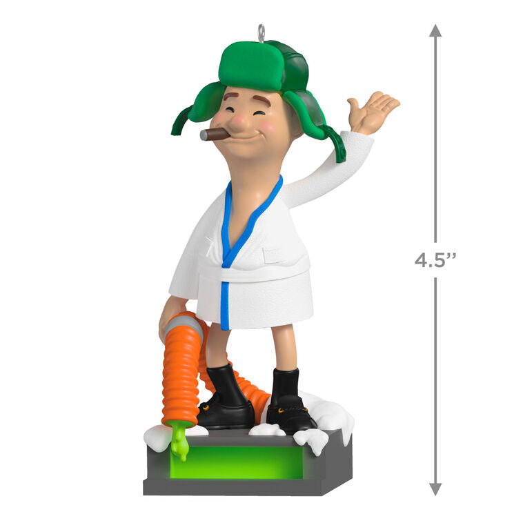 Cousin Eddie ornament from Hallmark Keepsake, wearing a bathrobe and trapper hat, standing next to an RV toilet from National Lampoon&