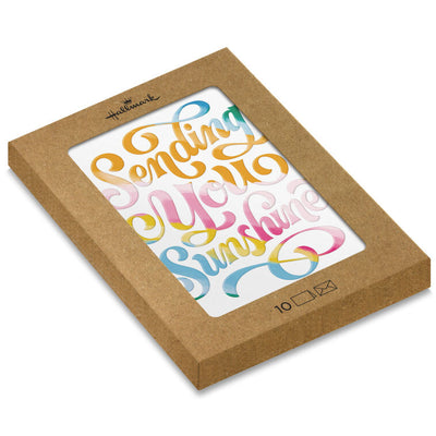 White blank note cards with colorful embossed “Sending You Sunshine” lettering in pink, orange, yellow, blue, and green.
