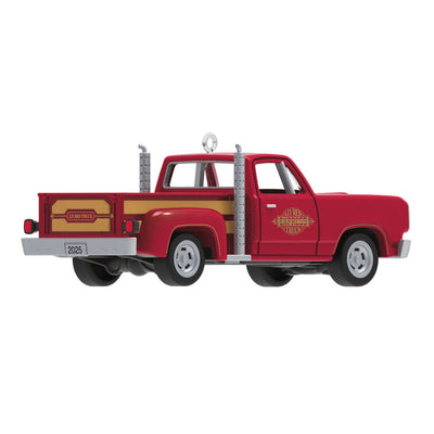 Miniature 1978 Dodge Li’l Red Express Christmas ornament in red and yellow with chrome stacks and turning wheels.