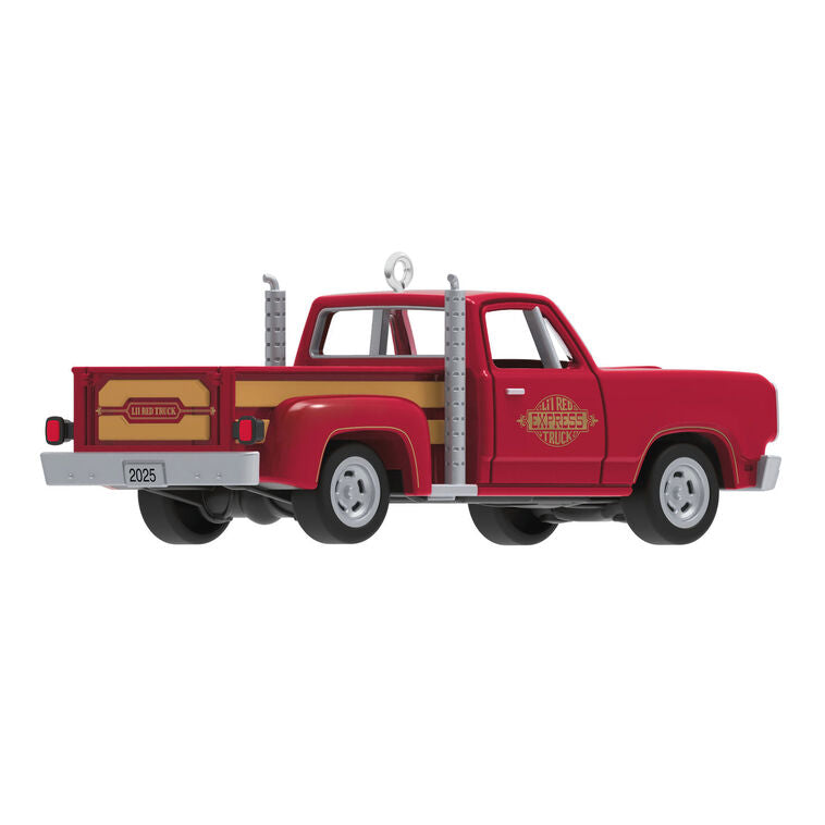 Miniature 1978 Dodge Li’l Red Express Christmas ornament in red and yellow with chrome stacks and turning wheels.
