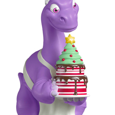 Purple Brachiosaurus in chef’s hat and apron holds a candy cane cake in this festive Hallmark Keepsake Christmas dinosaur ornament.