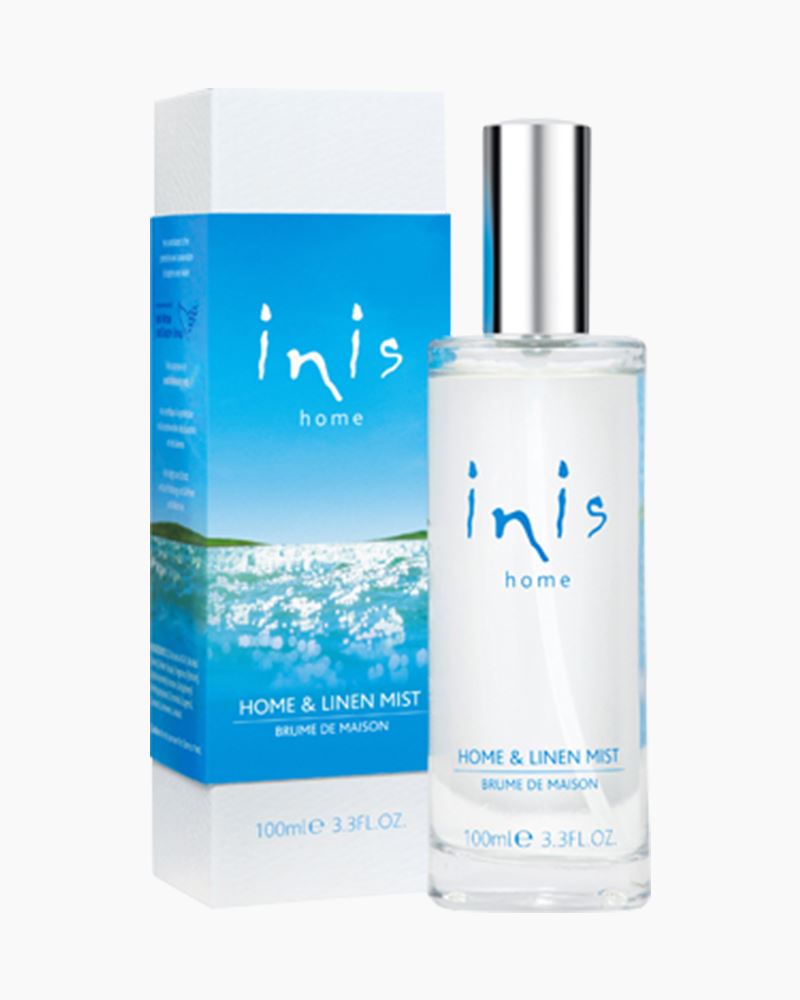 Clear bottle of Inis Home and Linen Mist Spray with white spray nozzle and ocean-themed label.