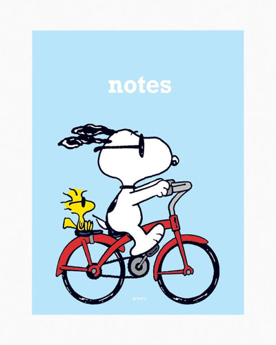 Peanuts Snoopy on bike pocket notepad with magnetic closure and colorful pages.