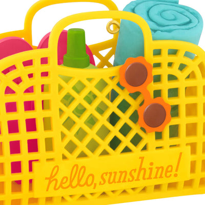Yellow beach bag ornament with flip-flops, swim towel, sunglasses, and sunscreen, perfect for summer-themed holiday decor

