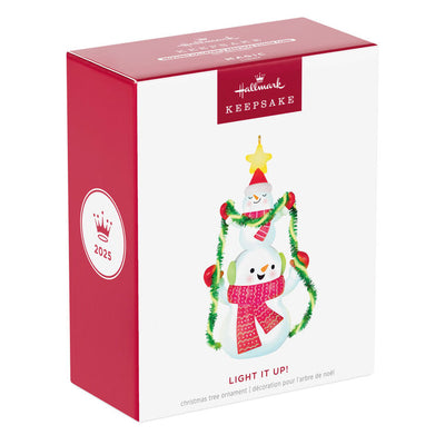 Stacked snowmen Christmas ornament wrapped in green tinsel garland with glowing star, battery operated light-up decor

