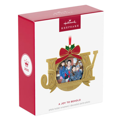 Gold JOY word-art photo frame ornament with red bow and holly topper, features 2025 date and holds a small holiday photo.