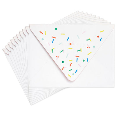 White envelopes with colorful confetti sprinkle design and orange flap interior, perfect for festive notes.
