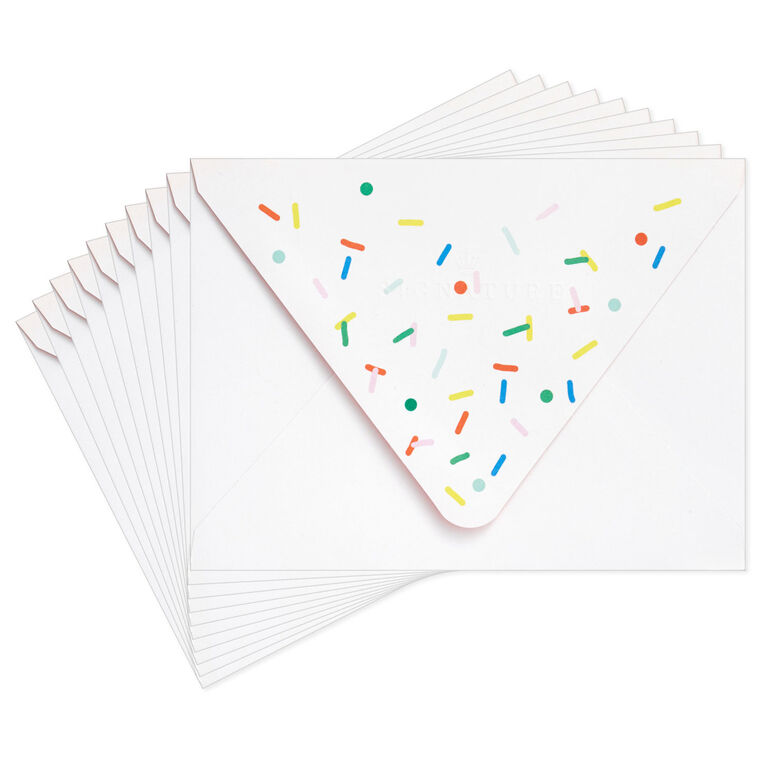 White envelopes with colorful confetti sprinkle design and orange flap interior, perfect for festive notes.
