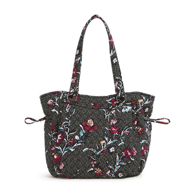 Black floral patterned Glenna Satchel with multiple exterior and interior pockets and adjustable drawstring

