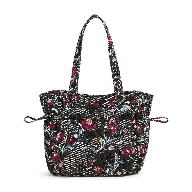 Black floral patterned Glenna Satchel with multiple exterior and interior pockets and adjustable drawstring
