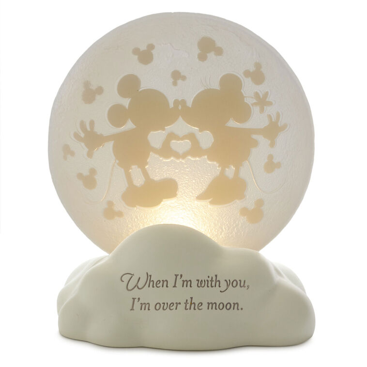 Light-up Mickey and Minnie figurine with heart hands silhouette on a frosted moon and “Over the moon” quote on the base.