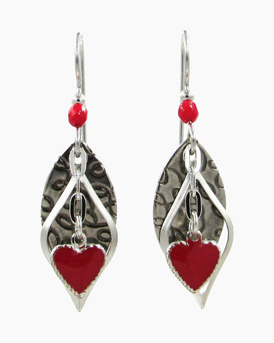 Layered heart dangle earrings with mixed metal tones and handcrafted detailing.
